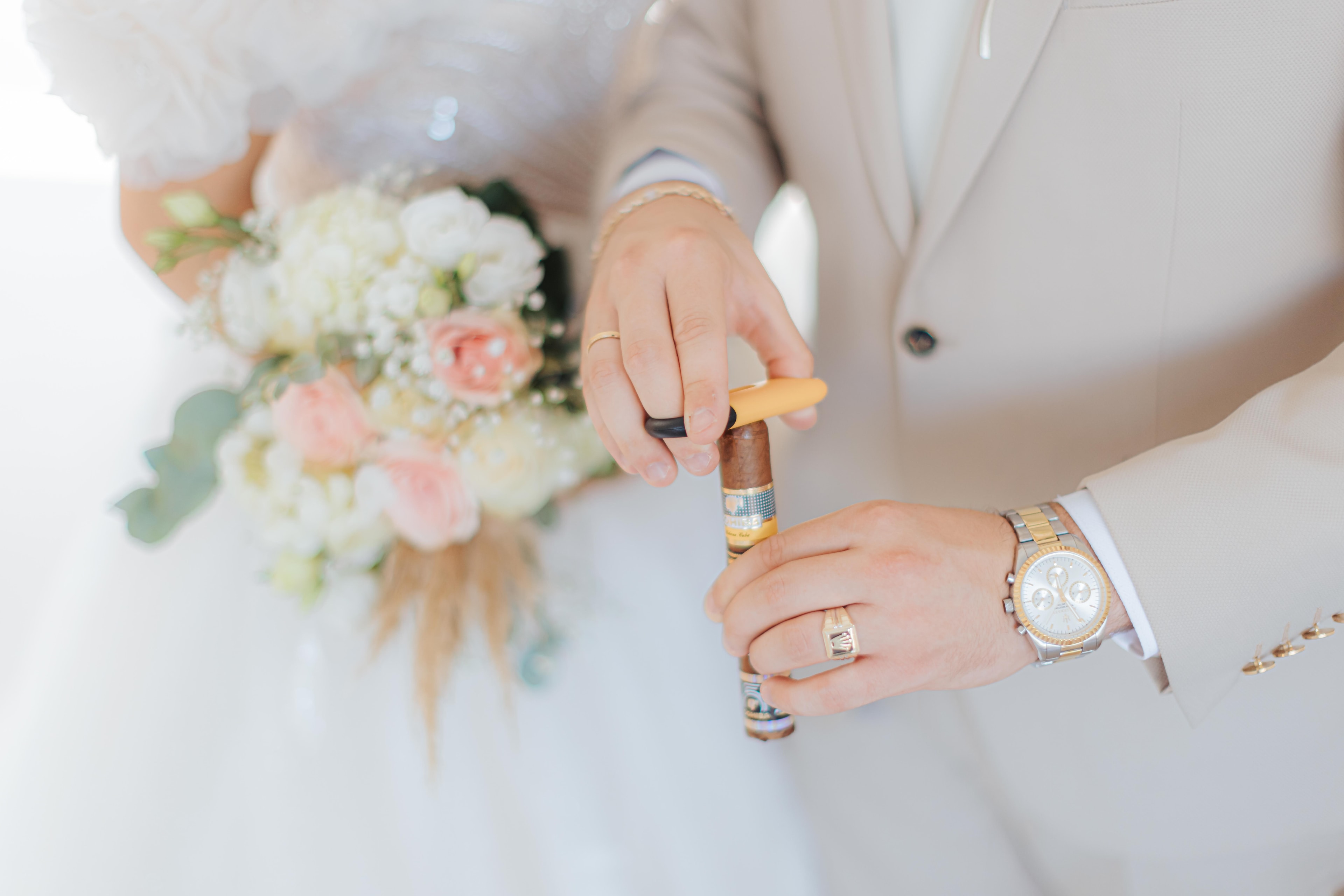 Mihalis preparing a cigar beside Varvara's bouquet