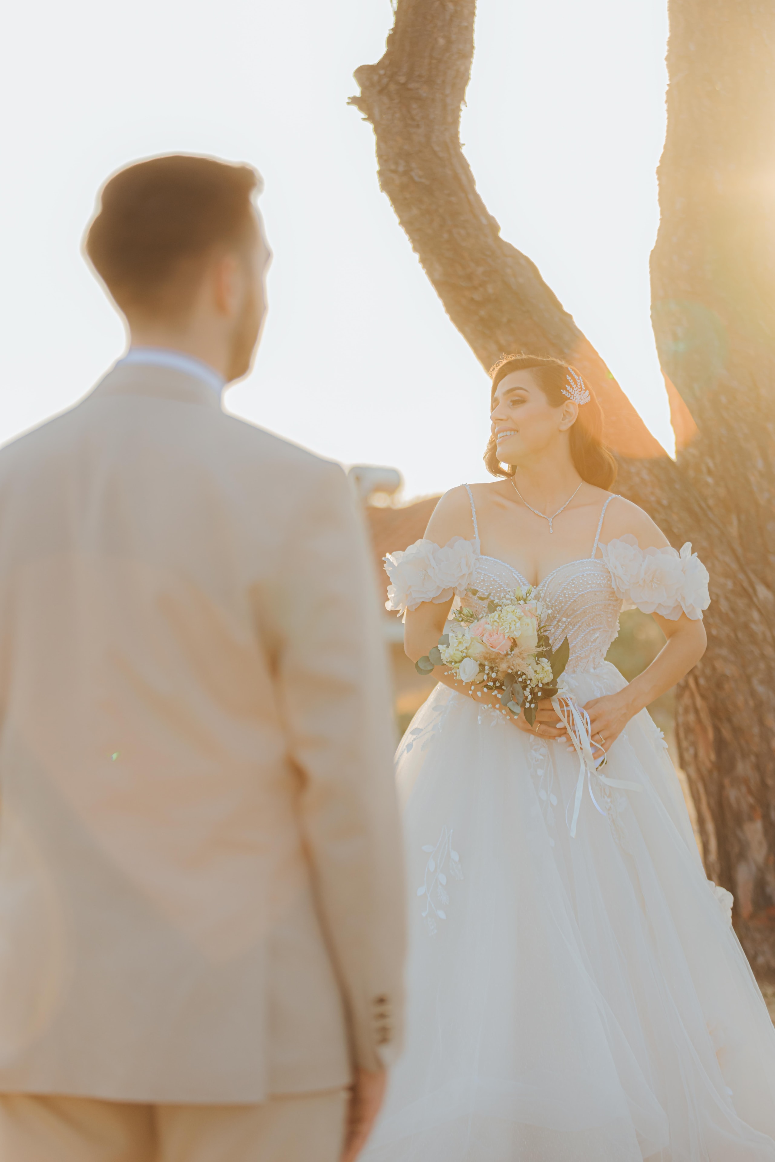 Varvara holding her bouquet facing Mihalis outdoors