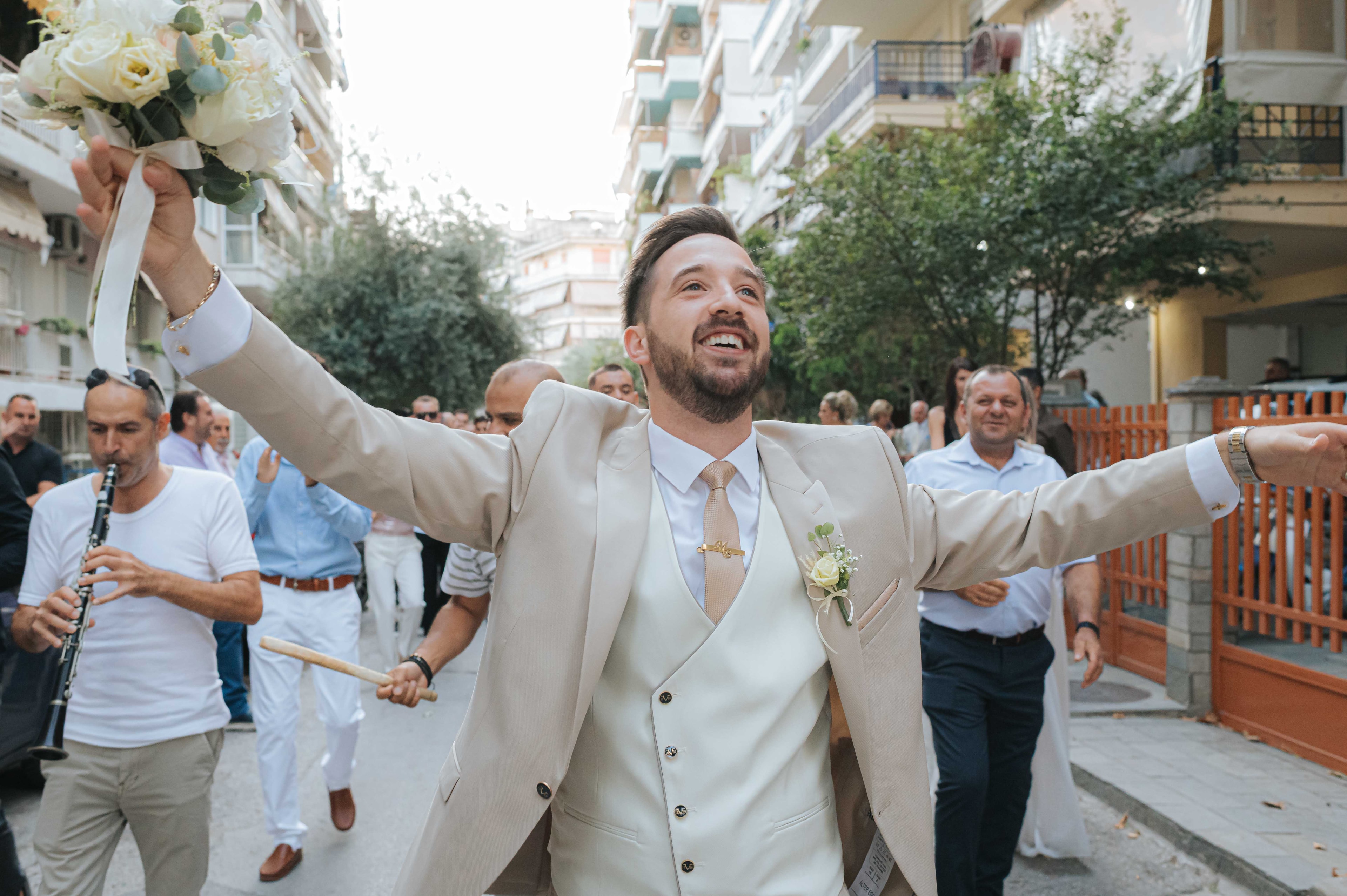 Mihalis celebrating with musicians and wedding guests