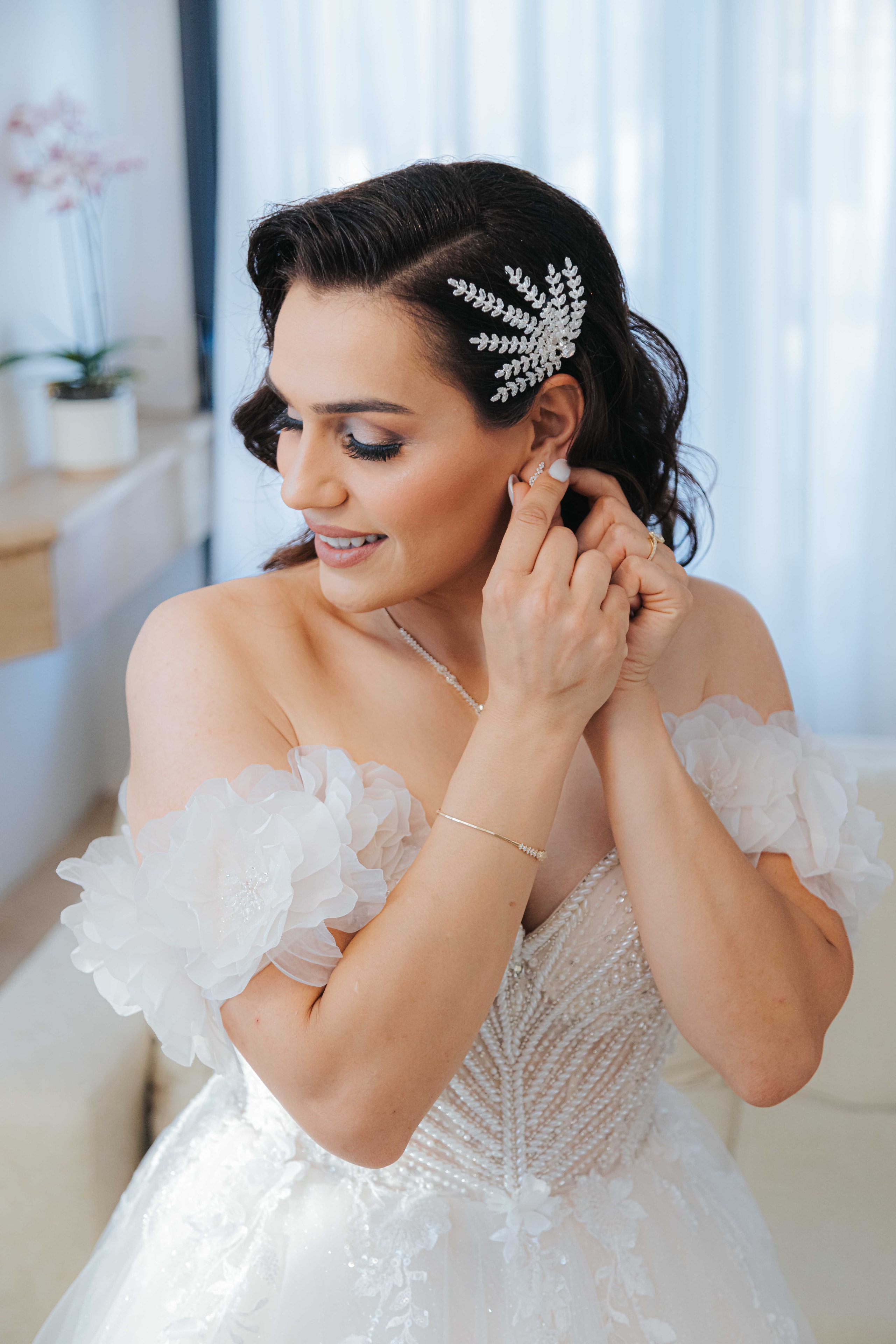 Varvara adjusting her earring before the ceremony