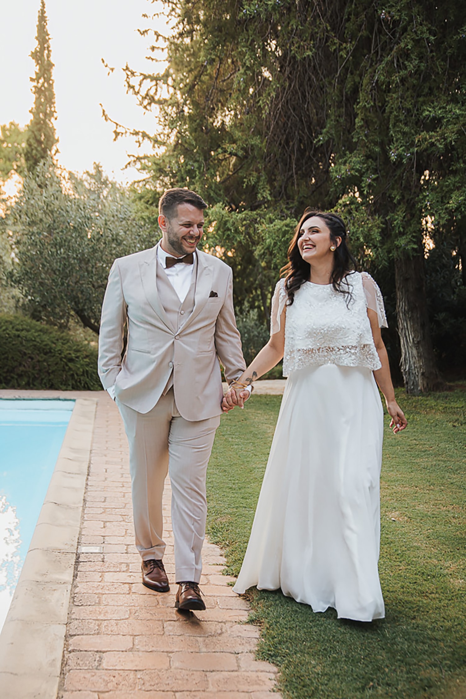 Xenofontas and Konstantina walking beside the pool