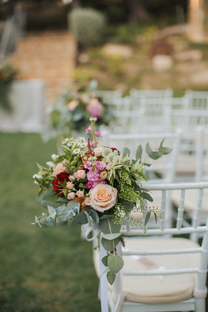Colorful wedding bouquet on a ceremony chair